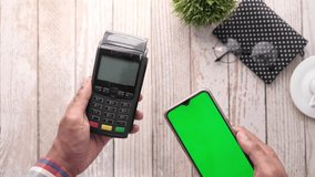 Payment terminal charging from a smart phone contactless payment. - Powered by Shutterstock - Get 15% off with code: PIKWIZARD15
