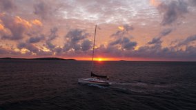 Sailboat sailing on the sea at sunset drone video