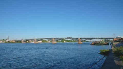 Panorama shot of the Theodor Heuss Brücke bridge between the cities mainz and wiesbaden, Hesse and rhineland palatinate with the river rhine and a cargo ship on a sunny summer day