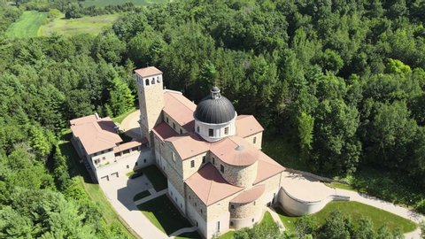 Top to down aerial of the catholic shrine of our Lady of Guadalupe in La Crosse Wisconsin, surrounded by dense greenery.