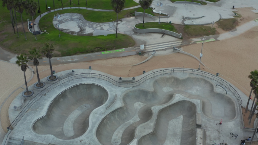 AERIAL: Close Up on Venice Beach Skate park empty in morning, Cloudy Los Angeles, California 