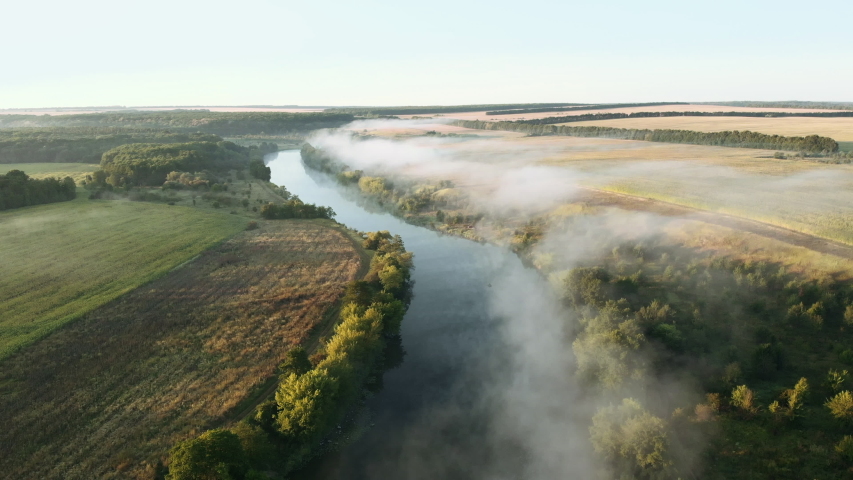 Beautiful River rapids in the fog in the morning. River water landscape. Flying from the drone through the morning fog over the river. Beautiful landscape. Forest river flow.