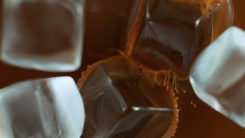 Super Slow Motion Shot of Ice Cubes Falling into Coffee at 1000 fps.