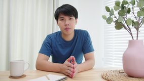 Confident Young Asian Businessman in casual clothes looking at the camera making video call conferences talking and discussing with a colleague or client online. remote working communication concept.