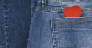Panorama of a red heart in a jeans pocket.