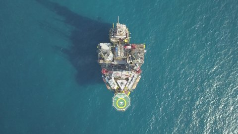 Aerial view from a drone of an offshore Supply Vessel For Oil Drilling Rig in The Middle of Ocean
