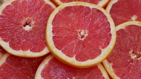 Macro Round Fresh Juicy Sliced Slices Of Red Citrus Grapefruit Rotate. Pieces of Grapefruit Fruit Isolated, Close-up. The Concept Of Healthy Eating.