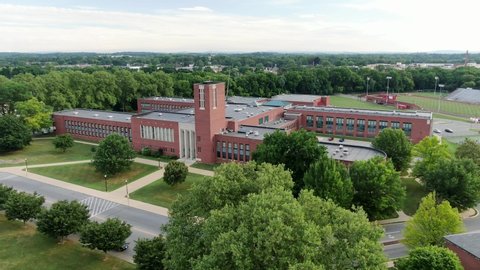 Aerial of large academic school building, higher education, public school building, beautiful cinematic establishing shot