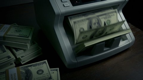 Money Counter Making Stack Of Hundred Dollar Bills