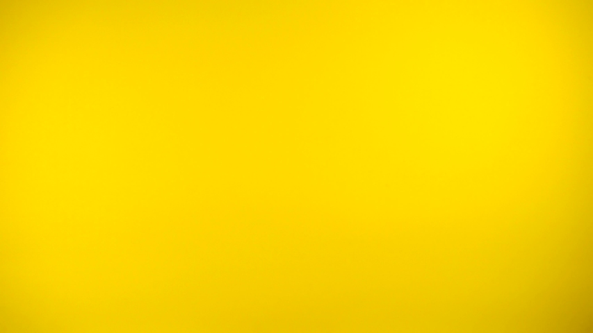 Hands show heart symbol fron fingers on yellow background, like gesturing