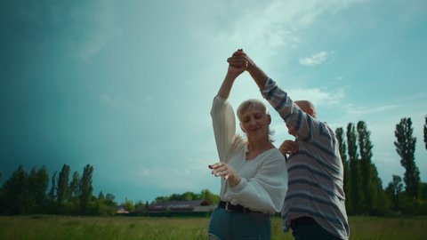 happy senior couple have romantic dating and dancing outdoor at sunset