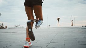 Close up view on running disabled woman with prosthesis