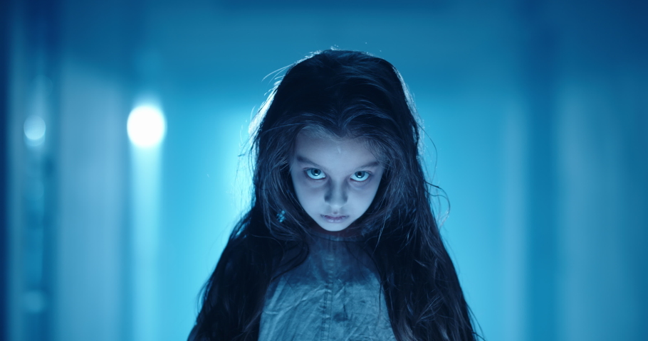 Girl in little white sundress creepily staring into camera, dressed for halloween. Child's ghost in haunted house - halloween costume party 4k footage | Shutterstock HD Video #1057993696