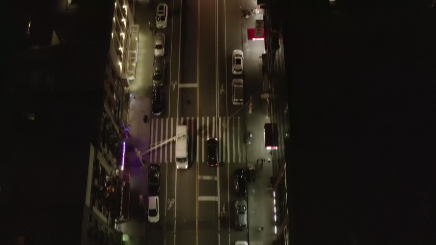 AERIAL: Overhead Top Down Follow Shot of Vehicle Car driving on Dark Road at Night in Chinatown, Manhattan, New York City Royalty-Free Stock Footage #1058001175