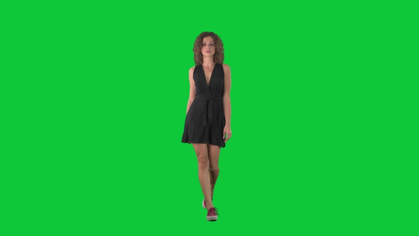 Young beauty woman fashion model walking on catwalk in slow motion on green screen chroma key background.  Royalty-Free Stock Footage #1058004175