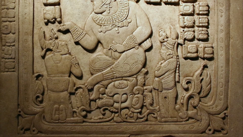 Bas relief depicting a god and people. Copan Ruinas in Honduras, archaeological site of the Maya civilization in the Copán Department of western Honduras, not far from the border with Guatemala. Royalty-Free Stock Footage #1058005213