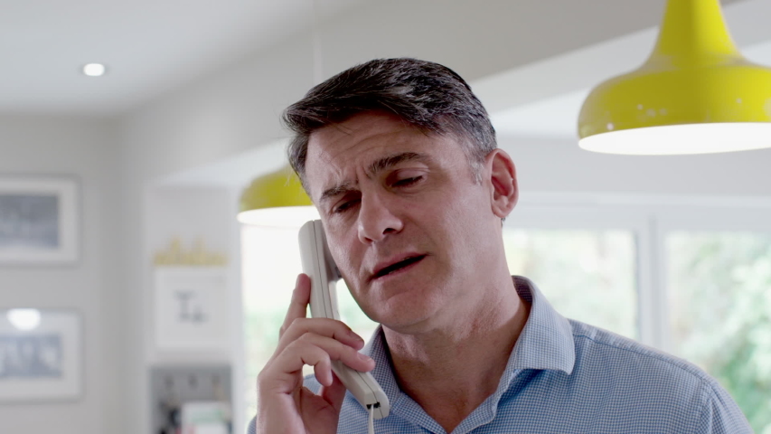 Unhappy Man On Phone At Home Answering Sales Call | Shutterstock HD Video #1058008915