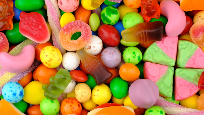Candy sweets background. Assorted colorful mixed candies. Colorful delicious sweets turning top view. | Shutterstock HD Video #1058018386