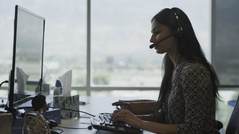 Businesswoman wearing headset talking in call center / Pleasant Grove, Utah, United States