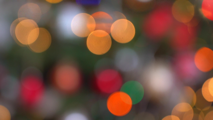 Shimmering abstract colored circles defocused christmas lights video. Blurred fairy lights. Out of focus holiday background christmas tree. Light bokeh from Xmas tree. Xmas and New Year theme. 4k  | Shutterstock HD Video #1058024920