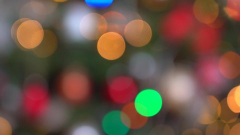 Shimmering abstract colored circles defocused christmas lights video. Blurred fairy lights. Out of focus holiday background christmas tree. Light bokeh from Xmas tree. Xmas and New Year theme. 4k 