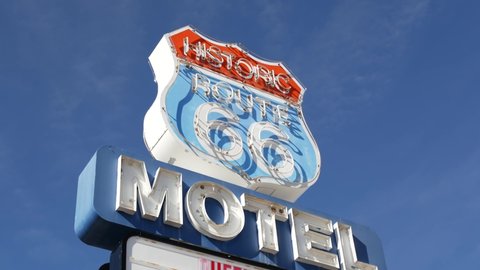 Motel retro sign on historic route 66 famous travel destination, vintage symbol of road trip in USA. Iconic lodging signboard in Arizona desert. Old-fashioned neon signage. Classic tourist landmark.