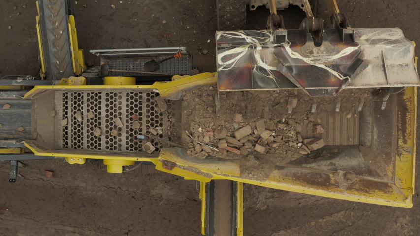Aerial top down view of construction waste sorter machine on cloudy day | Shutterstock HD Video #1058038288