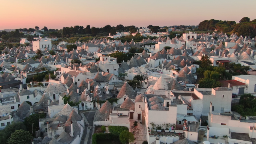aerial view of trulli of alberobello town apulia,drone fly over old town buildings at sunrise italy Royalty-Free Stock Footage #1058045326