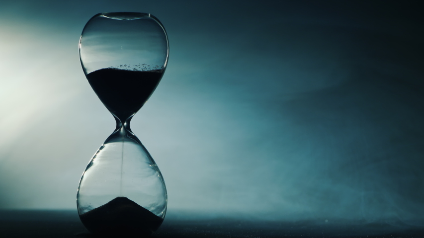 Dynamic light illuminates the hourglass in the fog