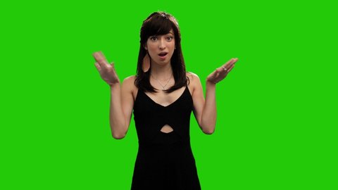 Cute Caucasian girl in black dress surprised on green screen