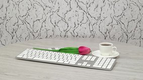 Office supplies with tea cup and keyboard on white spinning table background.