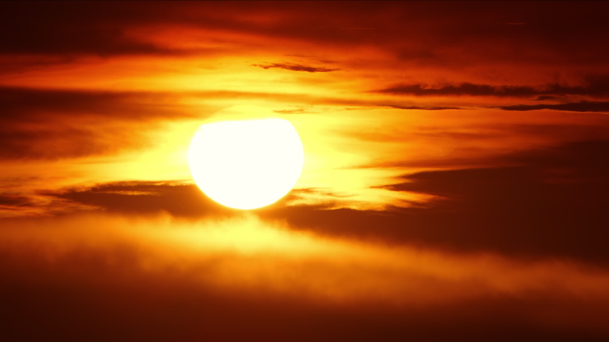 Beautiful Clear Big Sun at Sunrise or Sunset, Big Red Hot Sun in Warm Air Distortion Above Horizon Seamless. 4k Ultra HD | Shutterstock HD Video #1058071240
