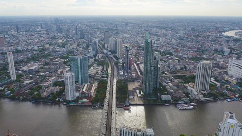 Aerial view of Bangkok Downtown Skyline with Chao Phraya River. Thailand. Financial district and business centers in smart urban city in Asia. Skyscraper and high-rise buildings at sunset.