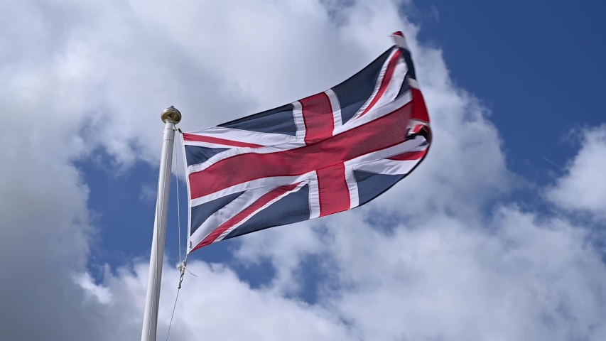 Union Jack flag of the United Kingdom proudly fluttering in the breeze. Royalty-Free Stock Footage #1058084833