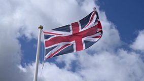 Union Jack flag of the United Kingdom proudly fluttering in the breeze. - Powered by Shutterstock - Get 15% off with code: PIKWIZARD15