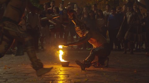 Valladolid, Yucatán/Mexico - February 16 2020: Some disguised mexican people dancing and playing with a fire flame with some public in the street at night
