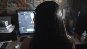 Girl in front of a computer working on a digital footage with video-editing software. 