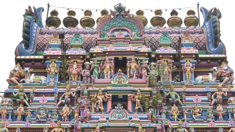 Close up of a colourful Gopuram (Temple entrance tower) with detailed artwork and figures of Hindu deities are carved on  the tower at Kapaleeshwarar Temple, Chennai, Tamil Nadu, India (February 2020)