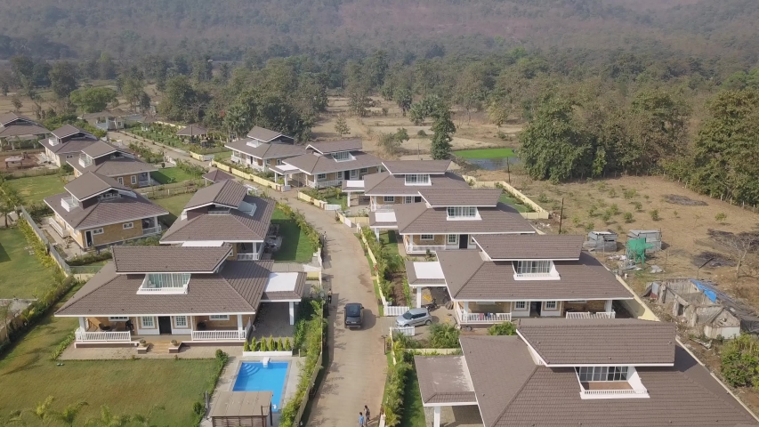 Car Heading Out Of The Beautiful Modern Residential Village At The Tract Housing Development During Daytime In Mumbai, India. - Aerial Shot