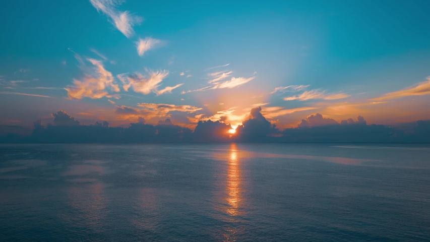 Sun rising from the sea. Colorful cloudy sky and sunbeams. 4k time lapse | Shutterstock HD Video #1058112784