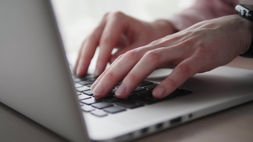 Closeup of hands of business person typing on laptop keyboard at the desk in home office. Closeup of female hands working on laptop keyboard. Businesswoman using laptop. Royalty-Free Stock Footage #1058117242