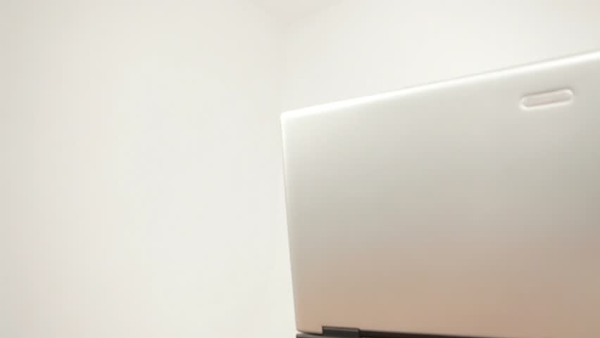 Close-up shot of a young girl enjoying herself while talking to another person on her laptop