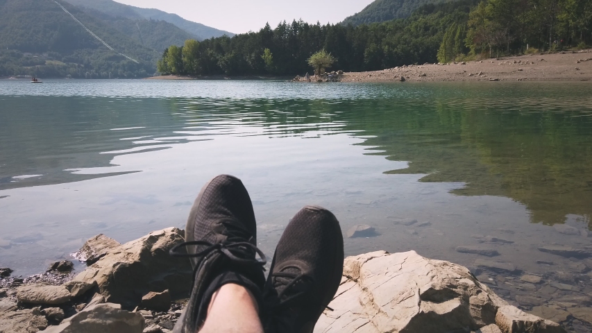 man enjoy relax at tranquil lake pov shot of shoes background . Royalty-Free Stock Footage #1058123767