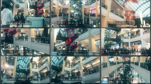 CCTV Security Cameras On Shopping Mall Multiscreen Surveillance. LISBON, PORTUGAL - 25 DECEMBER 2016; CCTV cameras surveillance system in a crowded shopping mall. Multiscreen monitor.