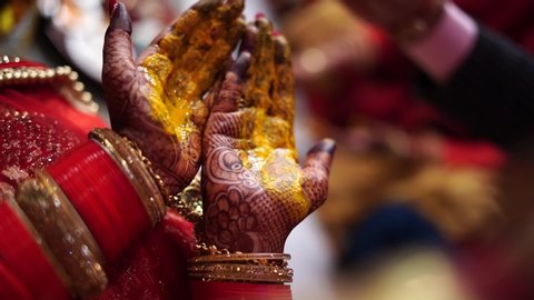 inside the Indian wedding, turmeric is used in the bride's hand before the wedding