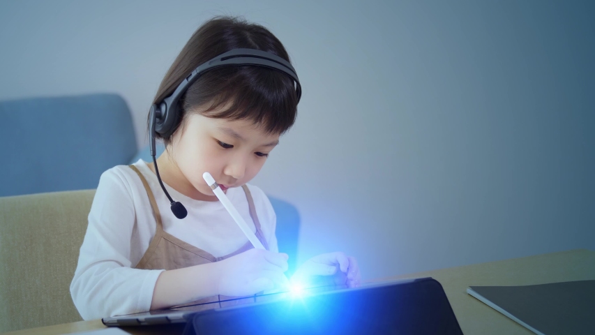 Asian little girl taking online class. Education technology. EdTech. Royalty-Free Stock Footage #1058135743