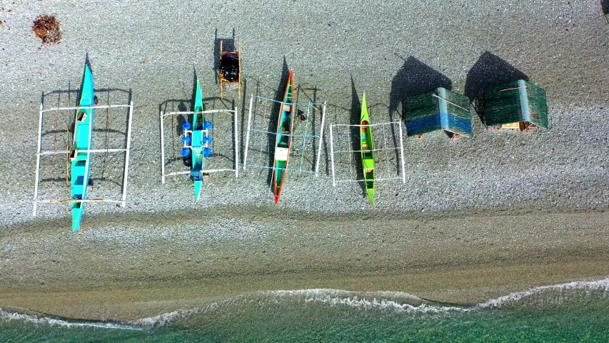 Banka coastal fishing boats on the shores of Mabua pebble beach Surigao aerial