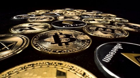 macro view rising over gold and silver cryptocurrency coins on black background, 4k blockchain altcoin investment