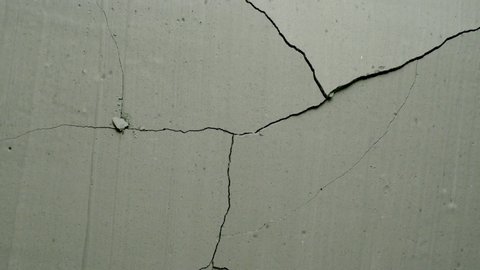 Effect of a grey concrete wall cracking from center from the Impact collection - Debris VFX Video Element.