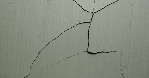 Effect of a grey concrete wall cracking from the top right side from the Impact collection - Debris VFX Video Element.